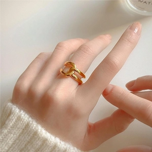Elegant 925 sterling silver gold interwoven chain ring worn by a model in soft knitwear