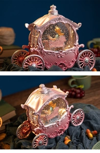 Detailed view of pink carriage music box with princess figure and floating glitter