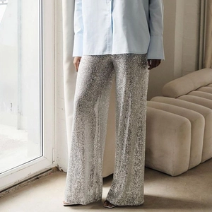 Close-up of shimmering silver sequins on these elegant wide-leg trousers for women