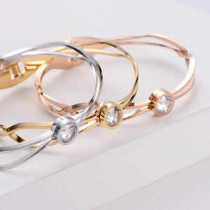 Minimalist twisted titanium steel bangle with round zircon in silver, gold, and rose gold