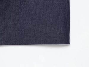Detailed close-up of dark blue denim midi dress hem with professional double stitching