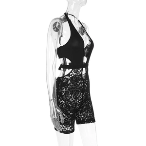 Side view of black lace jumpsuit with floral crochet textures and waist cutouts