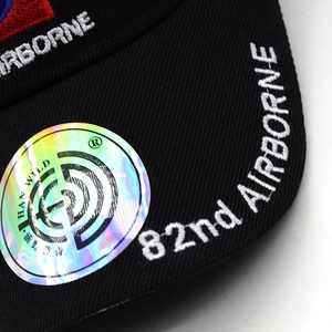 Macro detail of 82nd Airborne embroidery on a black cotton twill baseball cap visor