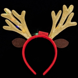 Detail of Christmas reindeer headband with LED lights and golden sequin antlers