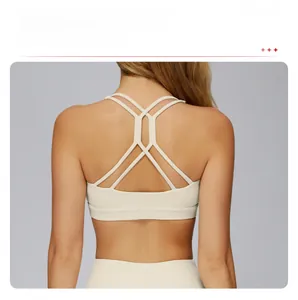 Detailed close-up of hollow-out cross-back design on cream yoga sports bra