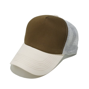 Detailed macro view of a breathable two-tone mesh trucker hat in brown and cream white