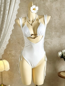 Elegant white cutout swimsuit with golden ring detail and side drawstrings on mannequin