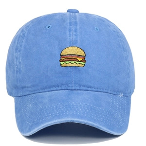 Detailed view of burger embroidery on washed blue cotton twill baseball cap