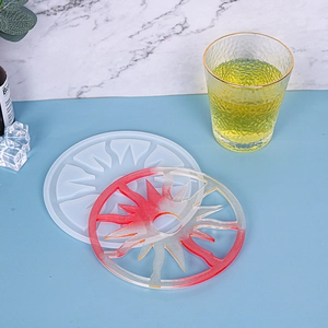 Detailed sunburst silicone mold and resin coaster with red and yellow glitter finish