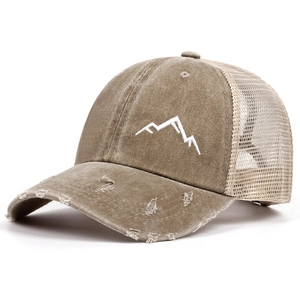 Detail of mountain embroidery and distressed brim on a mesh trucker baseball cap