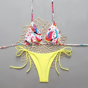 Flat lay of a bikini set with banana print halter top and yellow tie-side bottoms