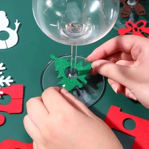Detail showing felt Christmas wine glass charms with snowman and tree shapes for holiday party