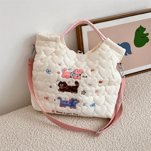 Detail of heart quilted tote bag with cute cat embroidery and pink checkered handle