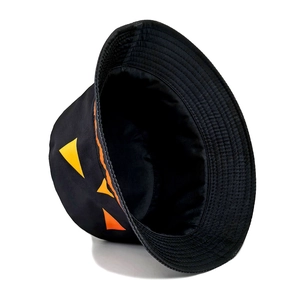Detail showing high-quality stitching and pumpkin face print on a black bucket hat