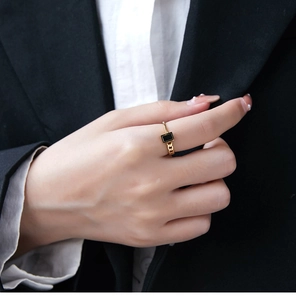 Detail of 18K gold plated ring with black rectangle inlay and curb chain texture