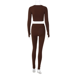 Back view of brown long sleeve crop top and high waist yoga pants on mannequin