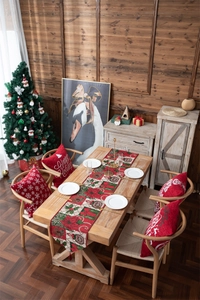 Close-up of festive Christmas table runner and pillow cases with holiday patterns