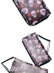 Three long leather wallets with skull, floral, and spider web prints with wrist straps