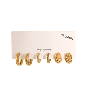 Three pairs of twisted 18k gold plated stainless steel hoop earrings on a white display card