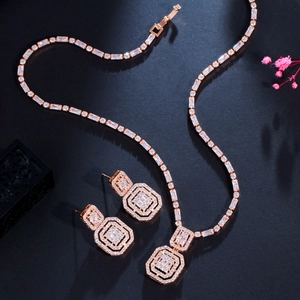 Detail of rose gold jewelry set with micro-paved square zircons and necklace pendant