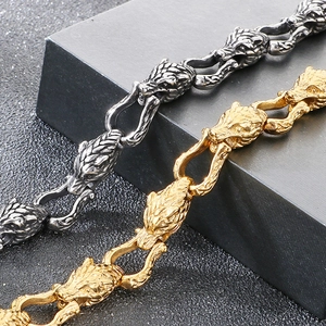 Close-up of Viking wolf head bracelets in gold and antique silver stainless steel