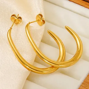 Vintage 18k gold plated stainless steel U-shaped drop earrings for women on white velvet