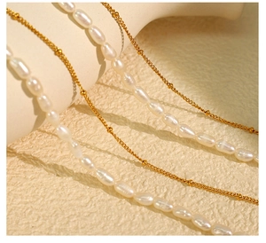 Detailed view of double-layer necklace with freshwater pearls and fine golden bead chains