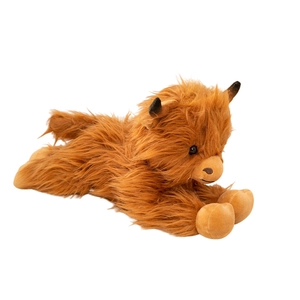Lying Scottish Highland cow plush toy with long fluffy reddish brown fur on white background