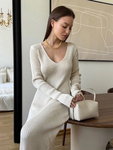 Elegant off-white V-neck long-sleeve knit dress with ribbed texture in modern home setting