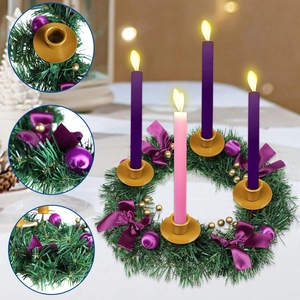 Christmas advent wreath with green pine branches, purple ribbons, and four LED candles