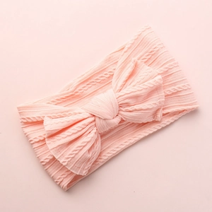 Premium soft pink nylon baby headband featuring a delicate jacquard bow design for infants