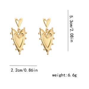 Detail view of gold vintage heart-shaped earrings with size metrics 5.3cm length