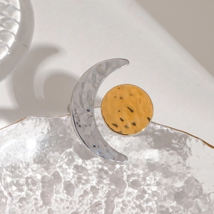 Macro detail of sun and moon mixed metal ring with handcrafted hammered texture finish