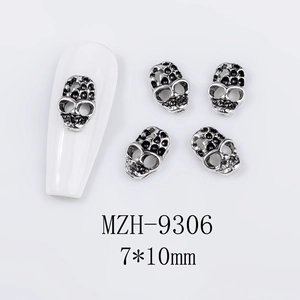 Detailed view of skull nail art charms in silver alloy for Halloween decorations