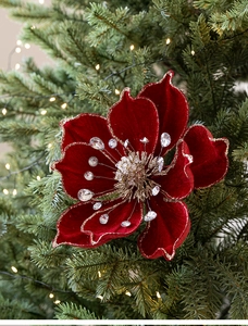 Detail of red velvet magnolia flower with gold glitter edges on Christmas tree