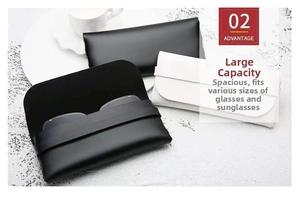 Detail view of black and white leather eyeglass pouches on a white marble surface