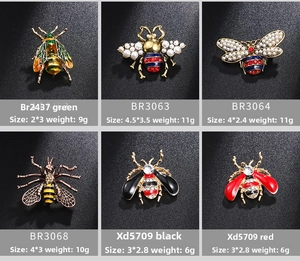 Macro details of bee and beetle insect brooches with enamel, pearls and rhinestones