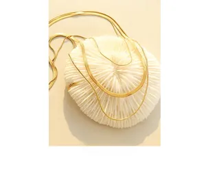 Close-up of golden layered snake chain necklace with elegant metallic texture