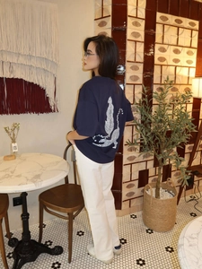 Detail of dark blue cotton T-shirt featuring a white leopard graphic print on the back