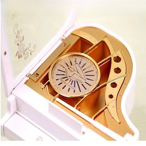 Macro detail of the golden mechanical movement inside a white piano music box
