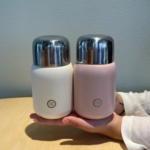 Mini stainless steel insulated tumblers in cream and pink colors with metallic lids