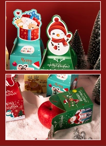 Detail of colorful Christmas apple boxes with cartoon patterns in a snowy scene