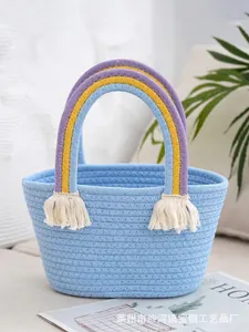 Handwoven light blue cotton rope bag with rainbow handles and white tassels for women