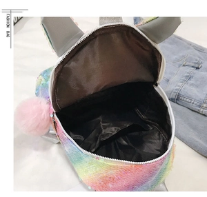 Internal view of colorful sequin unicorn backpack showing black lining and zipper