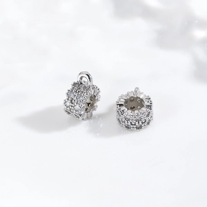 Macro detail of silver-plated copper spacer beads with brilliant cubic zirconia inlay
