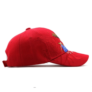 Macro side view of red cotton cap featuring eagle embroidery and star emblem detailing