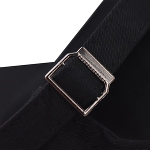 Detail view of the black washed cotton baseball cap with adjustable silver metal buckle