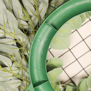 Rear view of green artificial eucalyptus wreath showing durable plastic ring base