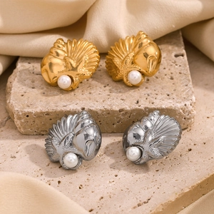 Marine style shell earrings in gold and silver plating with pearls on stone tile