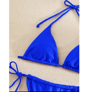 Detail of royal blue triangle bikini set with soft matte texture and halter ties